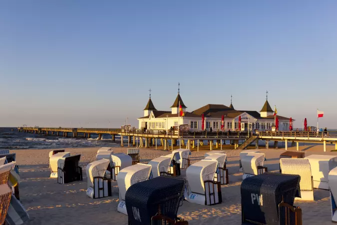 Pier with a building and beach chairs in Usedom